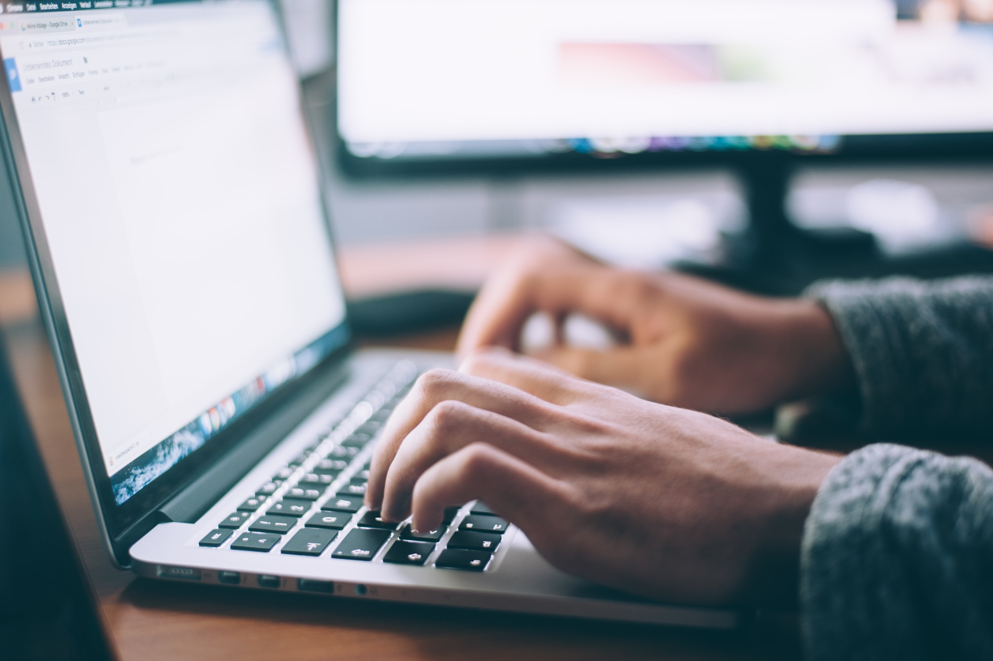 A person typing at a computer